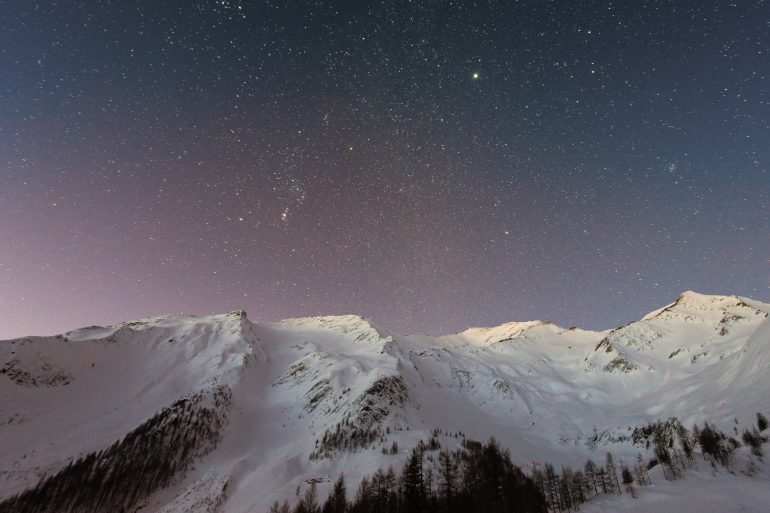 mountain covered snow under star
