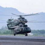 military commando helicopters landing on asphalt ground