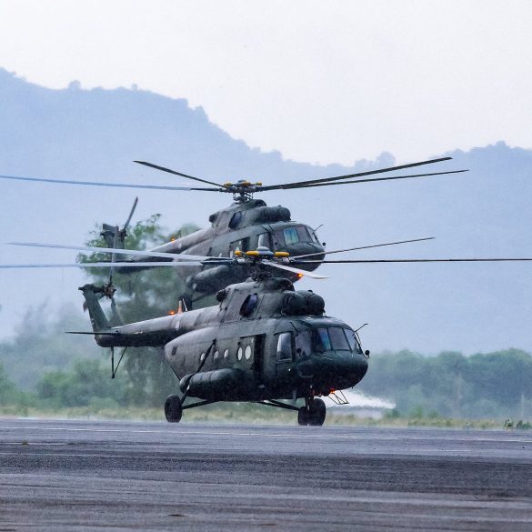 military commando helicopters landing on asphalt ground